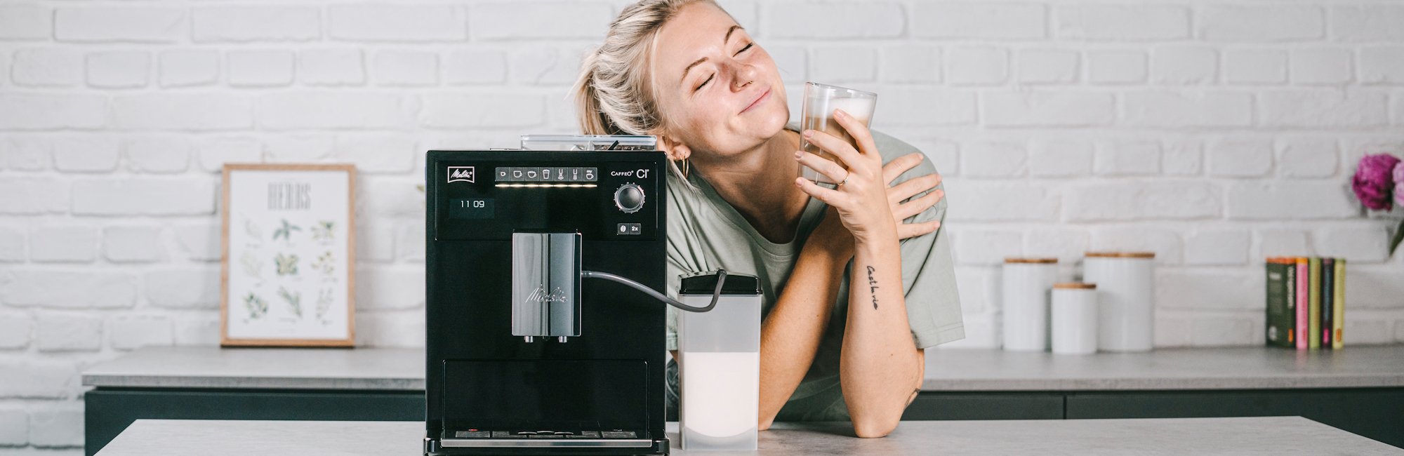 Melitta Caffeo CI with a woman enjoying a coffee