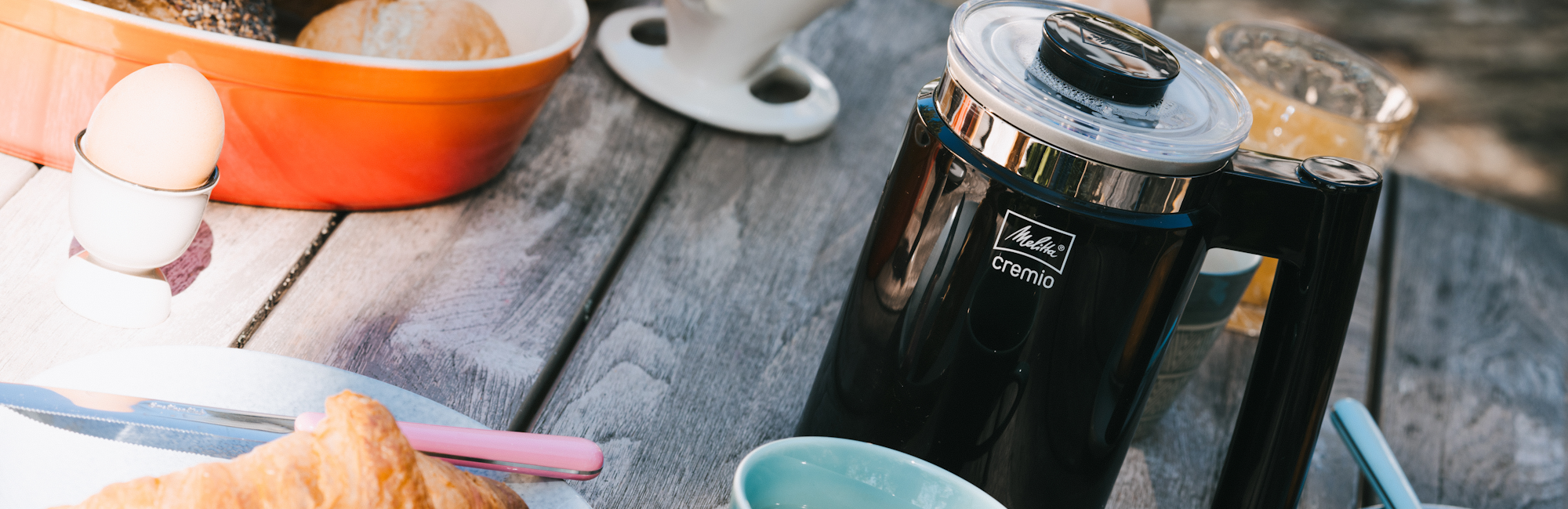 Image of our Cremio milk frother on a breakfast table