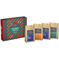 Verpackung vom Geschenkset der Melitta® Manufaktur, Aufschrift "Merry Xmas", daneben 4x 200g Tüten Kaffee