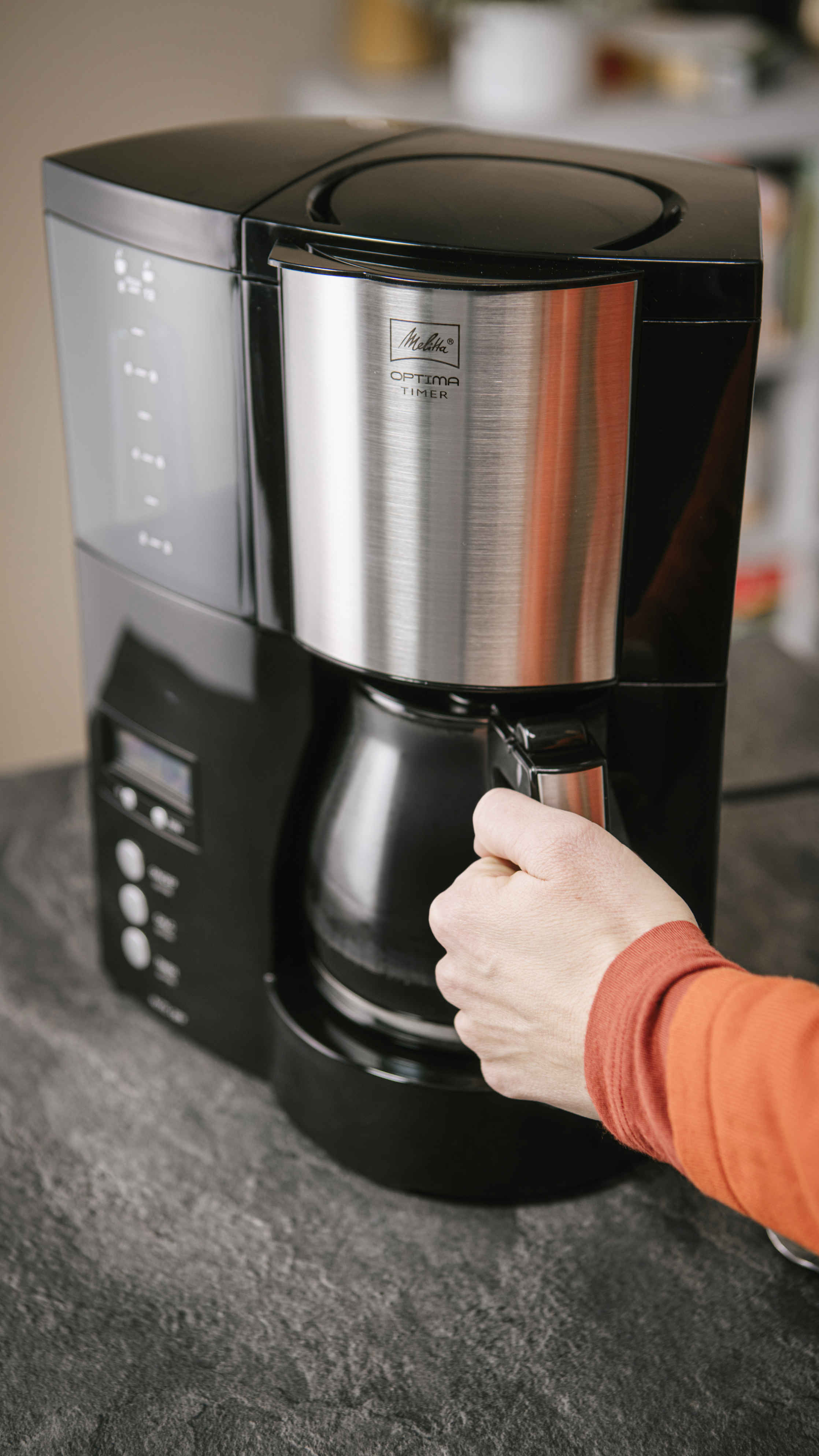 Melitta Optima Timer Filterkaffeemaschine mit Glaskanne, die von Hand entnommen wird
